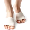 Women's feet wearing beige gel cushion ball of foot pads designed to relieve metatarsalgia, sesamoiditis, Morton's neuroma, arthritis, calluses, and blisters, featuring soft cushioning and a non-slip design for all-day comfort, displayed on a clean white background.