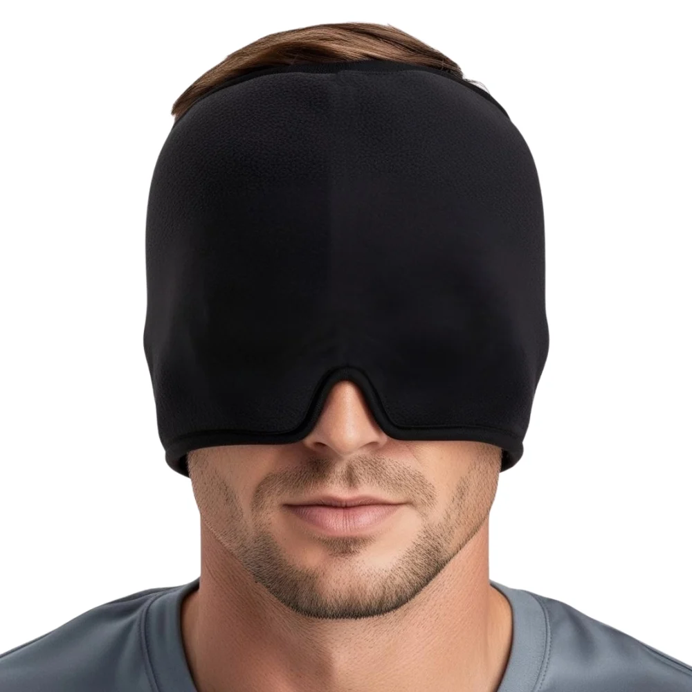 A man modeling a black migraine relief hat with a sleek, adjustable fit, showcasing soft, breathable fabric and subtle stitching designed for gentle compression around the temples and forehead. The minimalist design emphasizes comfort and functionality, with discreet contours that blend practicality and modern style.